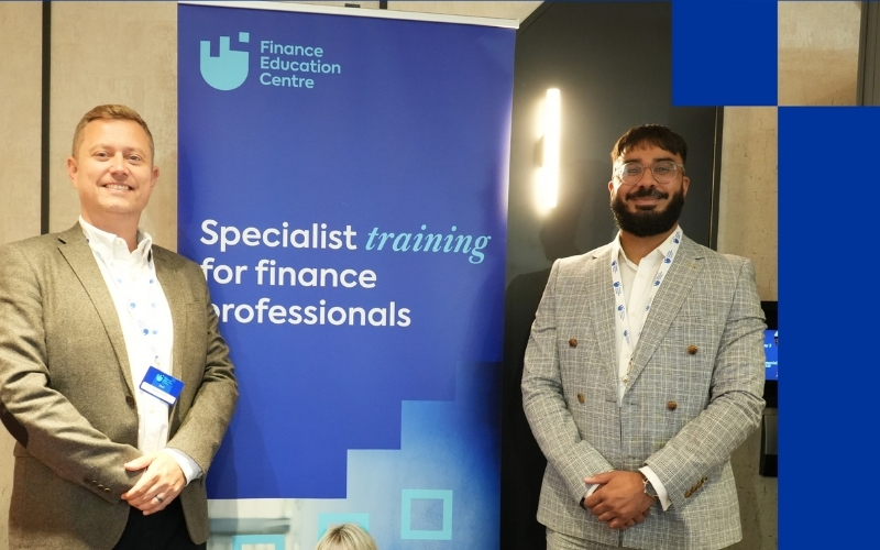 FEC staff at an event with banner in centre